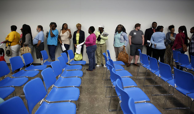 People line up for the chance to speak to representatives from the Department of Justice during a meeting held to talk about the agency's investigation of the Ferguson police department Wednesday, Sept. 24, 2014, in Ferguson, Mo. After an update on their investigation, members of the DOJ spoke with people individually about their interactions with Ferguson police and other law enforcement agencies in St. Louis County. (AP Photo/Jeff Roberson)